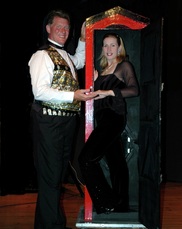Magician Mark Clark with his assistant Gerogette in one of the stage illusions.